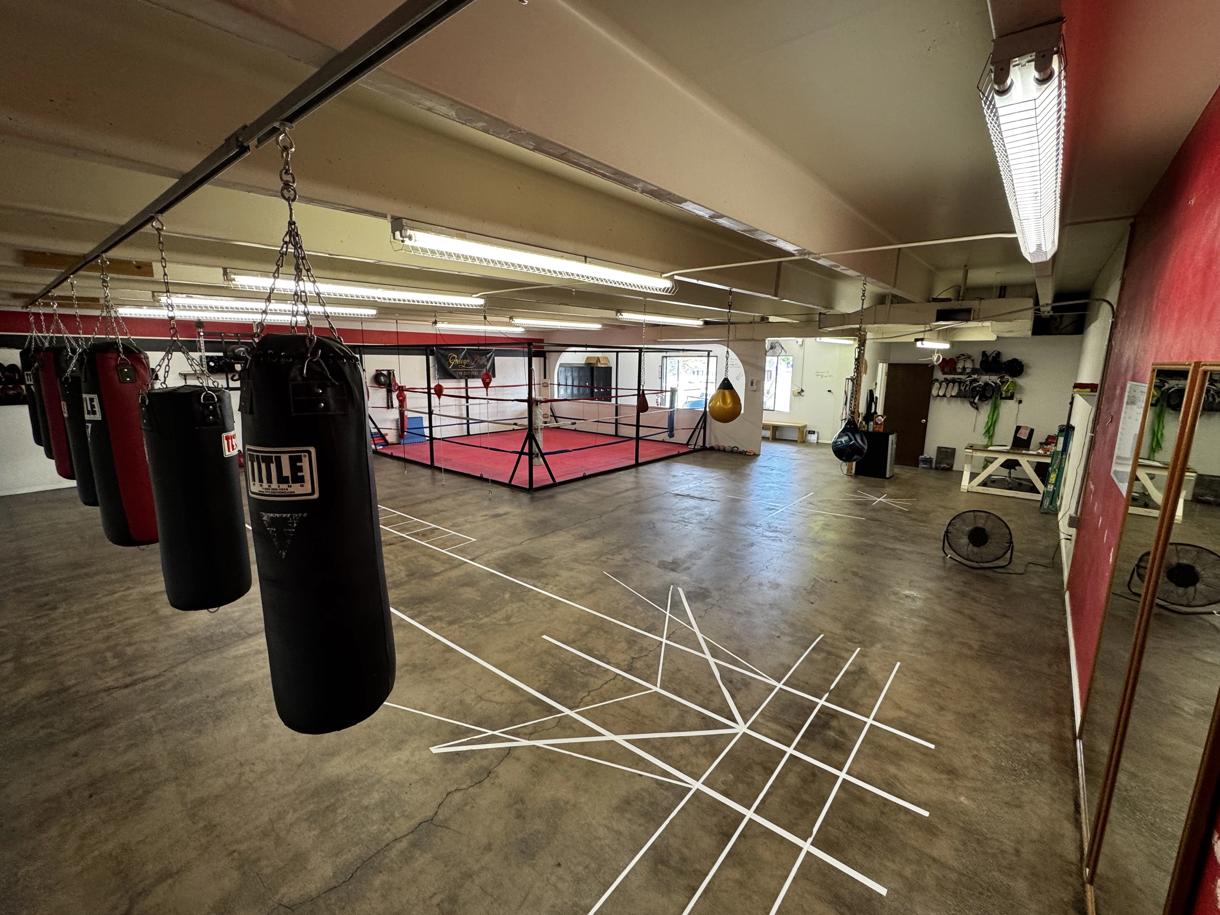 Heavy bag wall and training floor at Pugilistic Boxing Academy